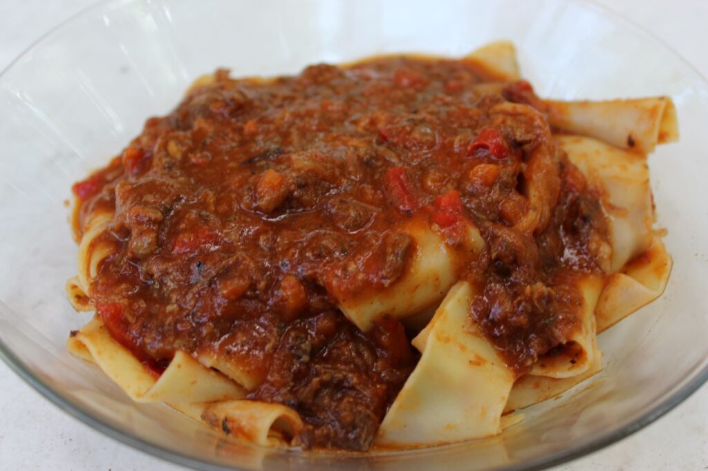 Pappardelle pasta with short rib meat sauce on top